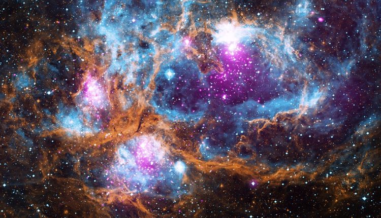 This composite image contains X-ray data from NASA’s Chandra X-ray Observatory and the ROSAT telescope (purple), infrared data from NASA’s Spitzer Space Telescope (orange), and optical data from the SuperCosmos Sky Survey (blue) made by the United Kingdom Infrared Telescope. Located in our galaxy about 5,500 light years from Earth, NGC 6357 is actually a “cluster of clusters,” containing at least three clusters of young stars, including many hot, massive, luminous stars. The X-rays from Chandra and ROSAT reveal hundreds of point sources, which are the young stars in NGC 6357, as well as diffuse X-ray emission from hot gas