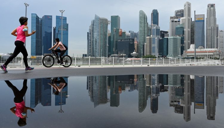 Singapore urges public to continue getting vaccinated as cases surge