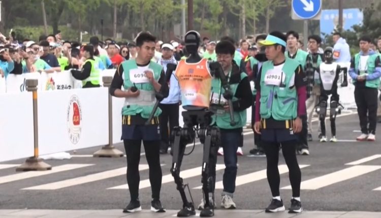 Humanoid robots lawn against people at unique half marathon in China

